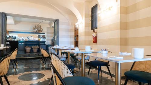 a row of tables and chairs in a restaurant at Hotel Ancora in Verbania