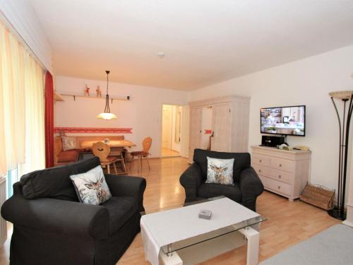 a living room with two couches and a table at Apartment Am Birkenhain-2 by Interhome in Seefeld in Tirol