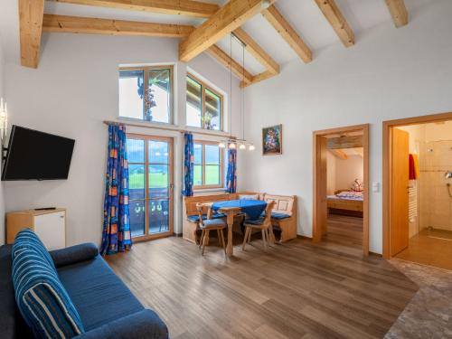 a living room with a blue couch and a table at Apartment Steinernes Meer by Interhome in Saalfelden am Steinernen Meer