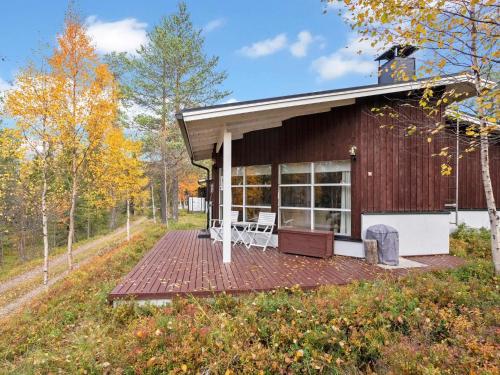 a house with a deck in the woods at Holiday Home Valkeisrinne m1 by Interhome in Ruka