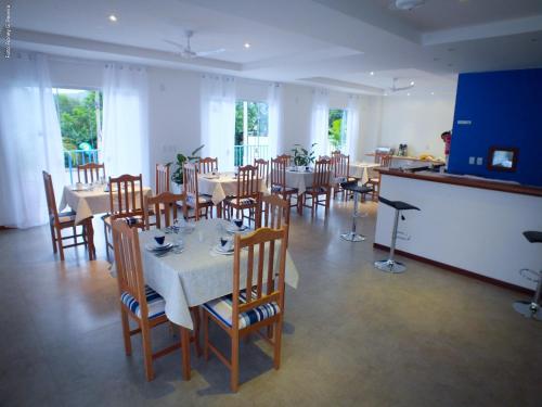 a dining room with tables and chairs in a restaurant at The Hyperion Boutique Hotel in Florianópolis