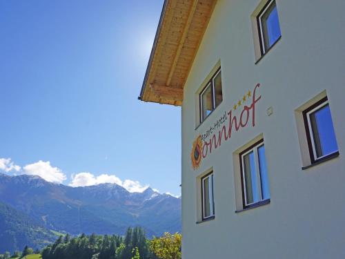 a sign on the side of a building with mountains in the background at Apartment Ladis-6 by Interhome in Ladis