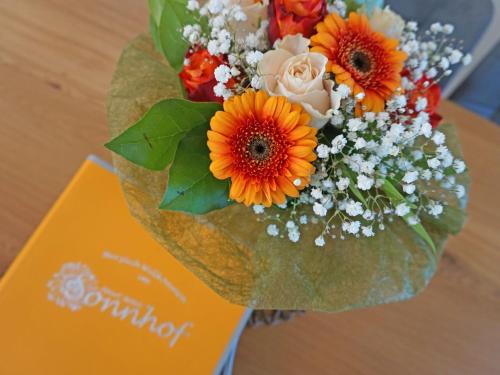 a bouquet of orange and white flowers on a table at Apartment Ladis-6 by Interhome in Ladis
