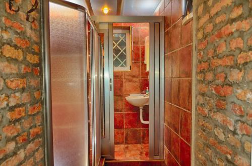 a bathroom with a sink and a toilet and a mirror at Studio 600 in Belgrade