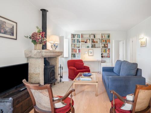 a living room with a blue couch and a fireplace at Holiday Home Casa da Quinta de Pedral by Interhome in Castelo do Neiva