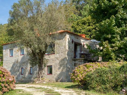 a stone house with a tree in front of it at Holiday Home Casa da Quinta de Pedral by Interhome in Castelo do Neiva