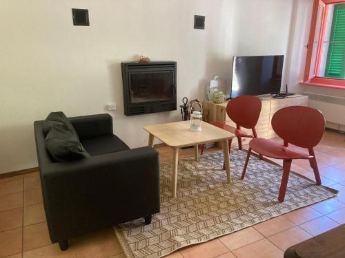 a living room with a couch and two chairs and a table at Holiday Home Casetta salita ai Castelli by Interhome in Bellinzona