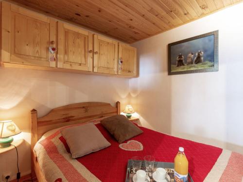 a bedroom with a bed with a red blanket at Apartment Grand Roc - Val Claret-1 by Interhome in Tignes