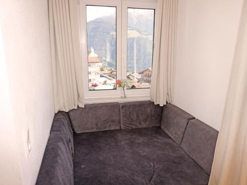 a room with a couch in front of a window at Apartment Ladis-10 by Interhome in Ladis