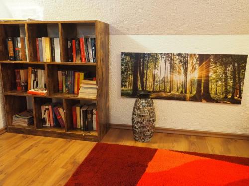 a room with two book shelves and a vase on a floor at Holiday Home Sissi by Interhome in Großschönau