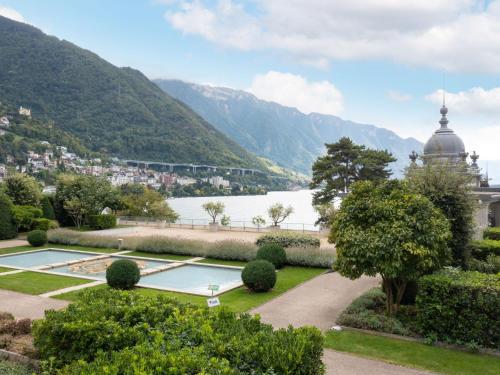 a garden with a view of a lake and mountains at Apartment Le Belvédère D2-6 by Interhome in Montreux