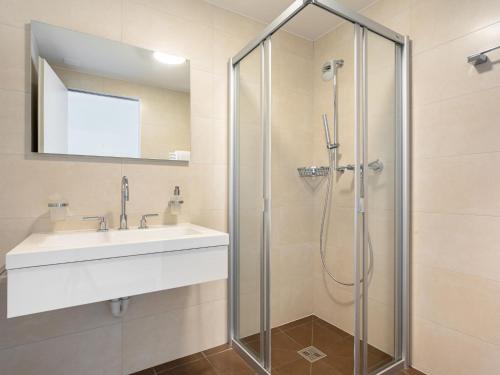 a bathroom with a sink and a shower at Apartment Le Belvédère D2-6 by Interhome in Montreux