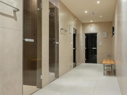 a bathroom with a walk in shower with a glass door at Apartment Le Belvédère D3-8 by Interhome in Montreux