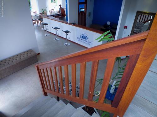 a wooden staircase with bar stools in a restaurant at The Hyperion Boutique Hotel in Florianópolis