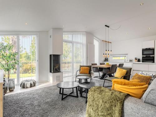 a living room with a couch and a table at Holiday Home Ruisweg 80 by Interhome in Wemeldinge