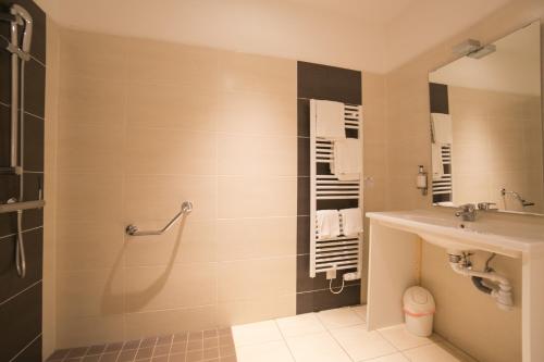 a bathroom with a sink and a shower at La Villa en L'île - 2 Piscines & Spa in Noirmoutier-en-l'lle