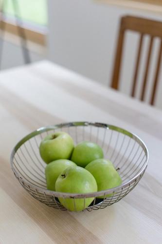 a bowl of green apples sitting on a table at am Greben Apartments drei - vier - fünf in Bezau