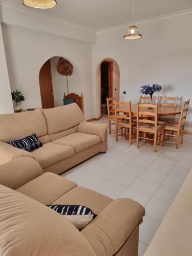 a living room with two couches and a dining room at Blue Waves Quiaios Apartment in Praia de Quiaos