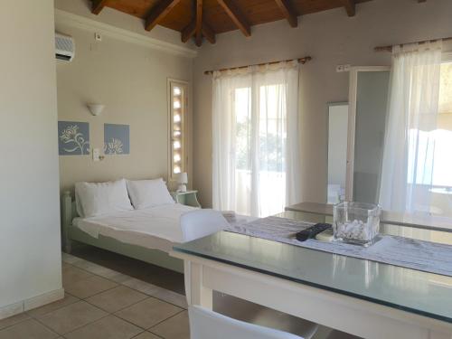 a bedroom with a bed and a glass counter top at 12 Gods Resort in Pylos