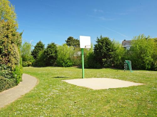 a sign in the middle of a park with a basketball hoop at Holiday Home Zeewind 145 by Interhome in Bredene