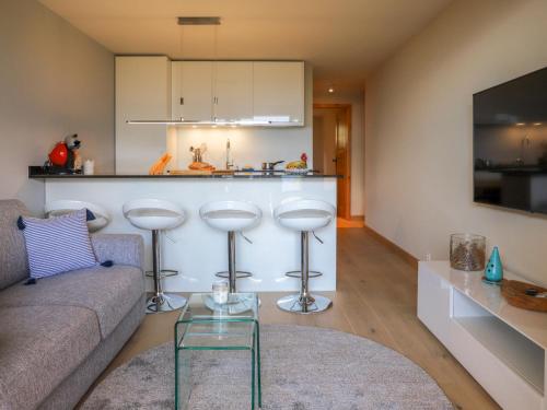 a living room with a couch and a kitchen at Apartment Chaperon Rouge A3 by Interhome in Chesières