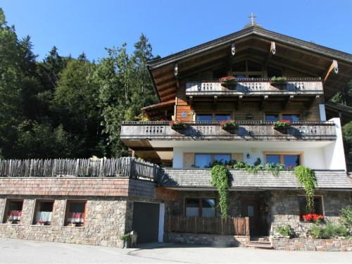 a house in the mountains with flowers on the balconies at Apartment Chalet Astholz by Interhome in Strass