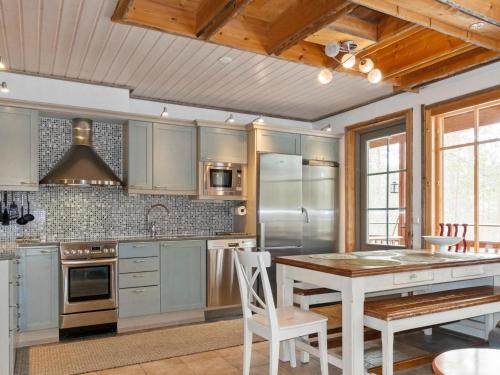 a kitchen with stainless steel appliances and a wooden ceiling at Holiday Home Nuovo casa b by Interhome in Sirkka