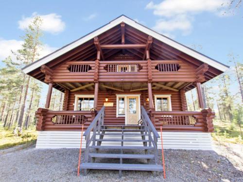 a log cabin with stairs leading to the front door at Holiday Home Lompakko by Interhome in Äkäslompolo