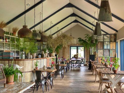 a restaurant with tables and chairs in a room at The Stable Yard House at Burtown House & Gardens in Athy