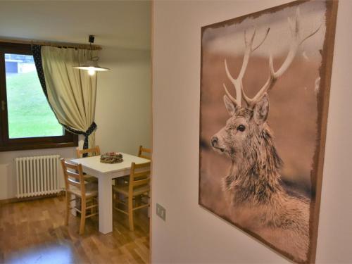 a picture of a deer hanging on a wall in a room at Studio Frassan Apartments-3 by Interhome in Madonna di Campiglio