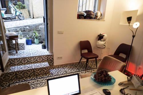 a room with a desk with a laptop and chairs at Kumbaracı Apartments & Suites in Istanbul