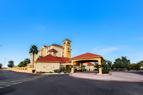 a building with a clock tower in a parking lot at La Quinta by Wyndham Mesa Superstition Springs in Mesa