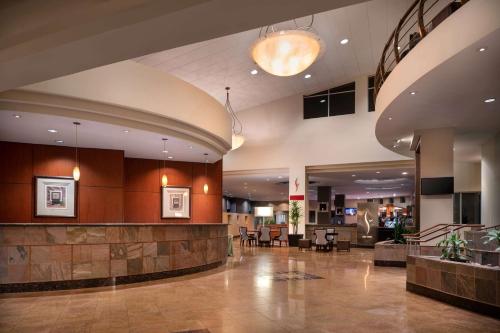 a lobby of a hotel with a waiting area at Wyndham Phoenix Airport - Tempe in Tempe