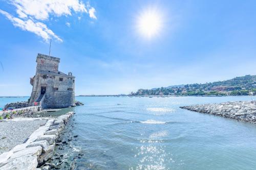 a body of water with a tower in the middle at [Portofino] Appartamento a un passo dal mare - Free Wi-Fi in Rapallo