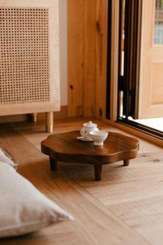 a wooden coffee table with a tea set on it at Gyeongju Hanok Sohwa in Gyeongju