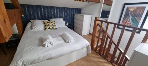 a bedroom with a bed with two pillows on it at Appartement T2- Le bon accueil / WIFI / PARKING in Angoulême