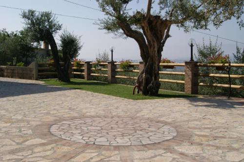 un albero nel mezzo di una passerella di mattoni con un albero di DA LELLO - Bed & Relax a Torrecuso