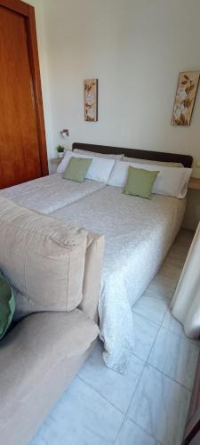 a large bed sitting in a room with at Apartamento Fibes y Congresos in Seville