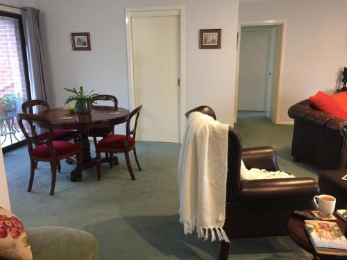 a living room with a table and a couch at Bird Abode in Maryborough