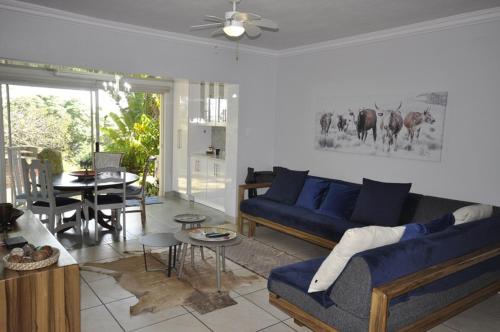 a living room with a blue couch and a table at The Bridge Apartments, Unit 34 in St Lucia