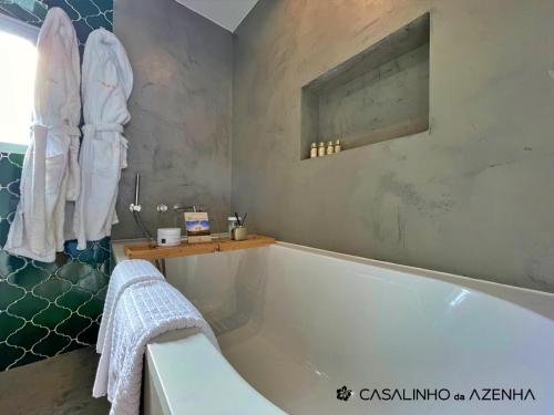 a bathroom with a bath tub and a sink at Casalinho da Azenha - Charm House in Sintra