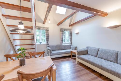 a living room with a couch and a table at Bramslevgaard in Hobro