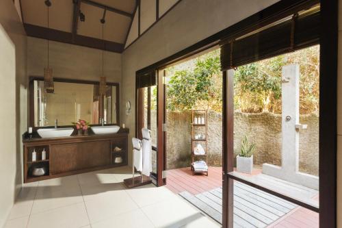 a bathroom with a sink and a mirror at Uga Jungle Beach in Trincomalee