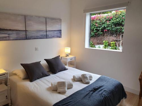 una camera da letto con un letto e due asciugamani di Cozy and intimate bungalow in Puerto de la Cruz a Puerto de la Cruz