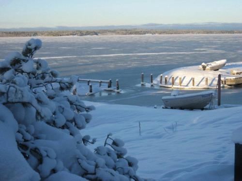 a field covered in snow with a plane in the distance at Norrö Holiday Village in Bamböle