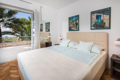 a bedroom with a large bed and a balcony at Kazimir in Zavala