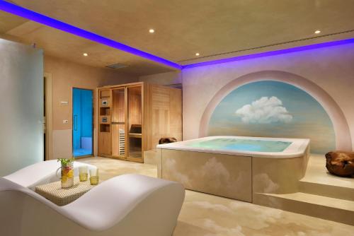 a bathroom with a bath tub with a window at Leon's Place Hotel In Rome in Rome