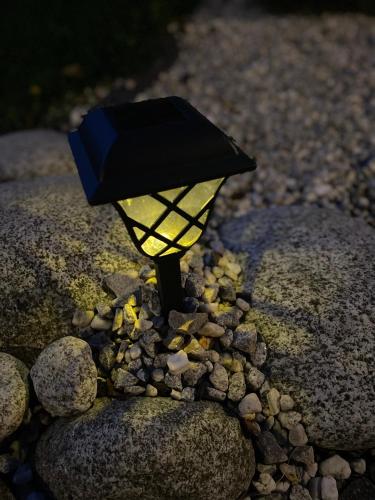 a candle on a rock with a black top at Willa Aleksandra - Apartamenty in Międzybrodzie Żywieckie