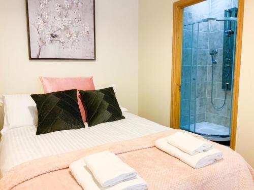 a bedroom with a bed with two towels on it at Battersea apartment in London