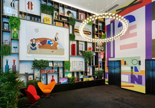 a lobby with colorful walls and a chandelier at citizenM Chicago Downtown in Chicago